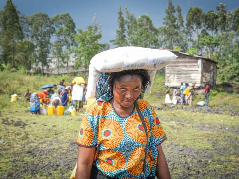 Furaini Chiko, mother of six and World Vision programme participant receives her empowerment kit from World Vision